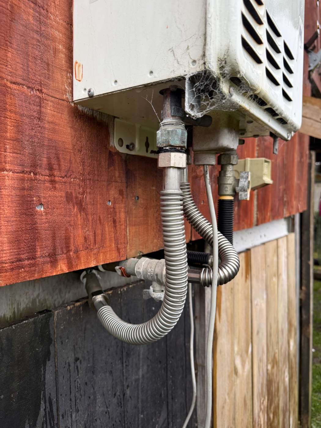 The water connections and pipework below a continuous flow gas water heater